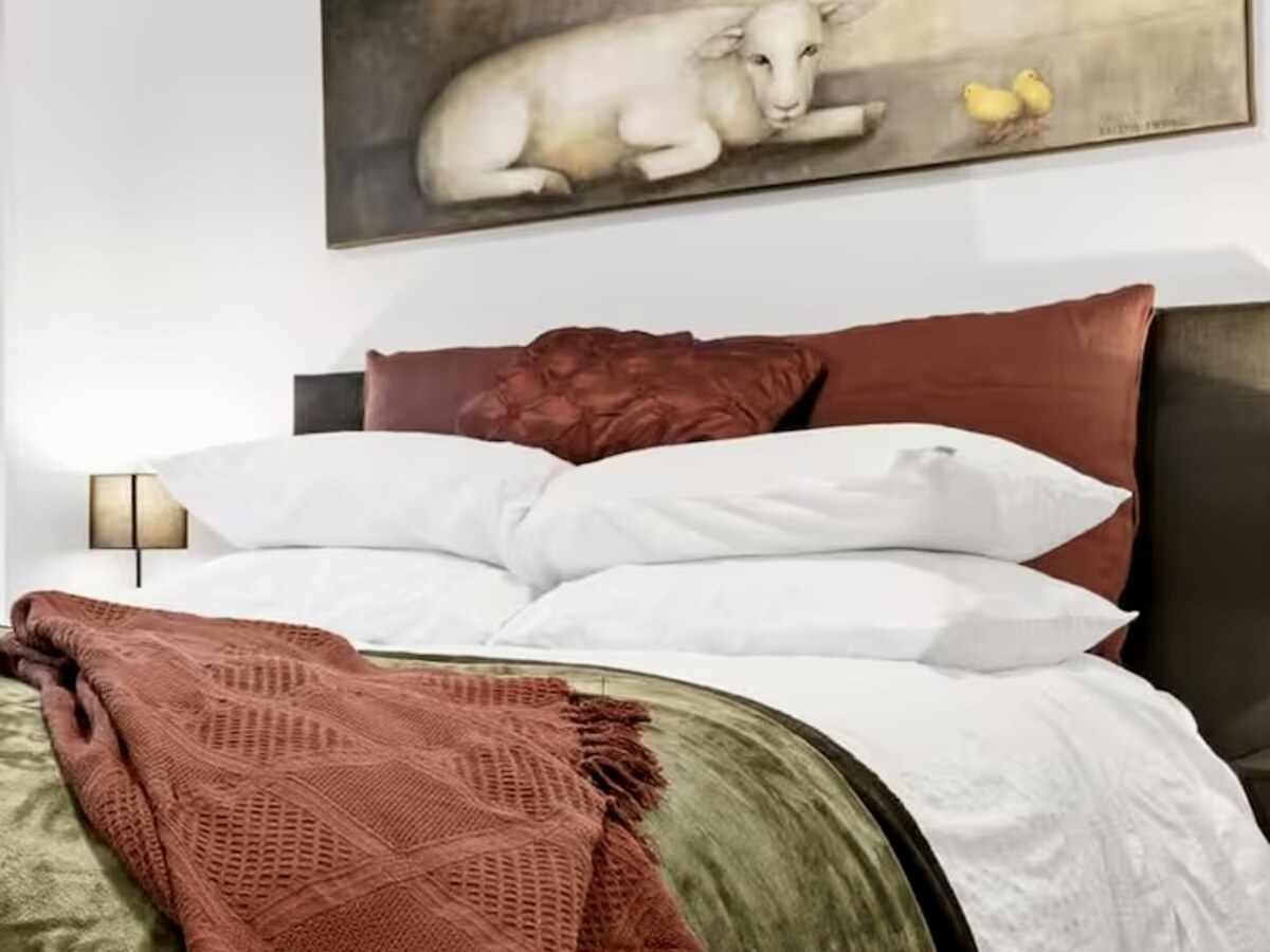 Bedroom after: a tighter composition centred on the bed and its layered textures